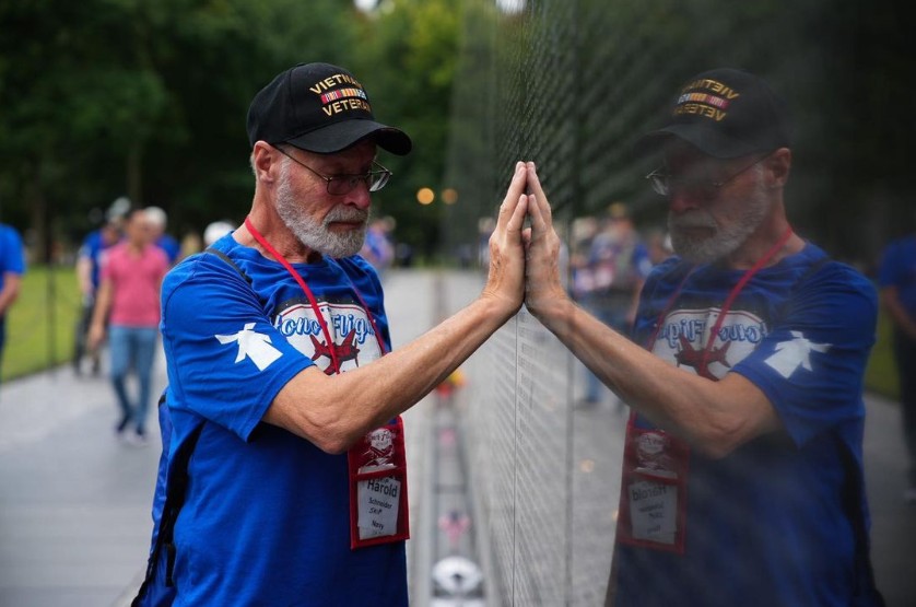 An elderly military veteran touches the wall at the Veterans Memorial in Washington, DC.