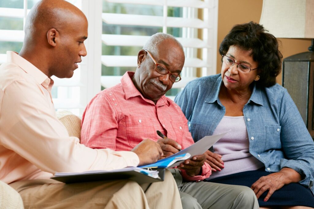 An African-American senior couple speak with their son about advance care plans and advance directives.