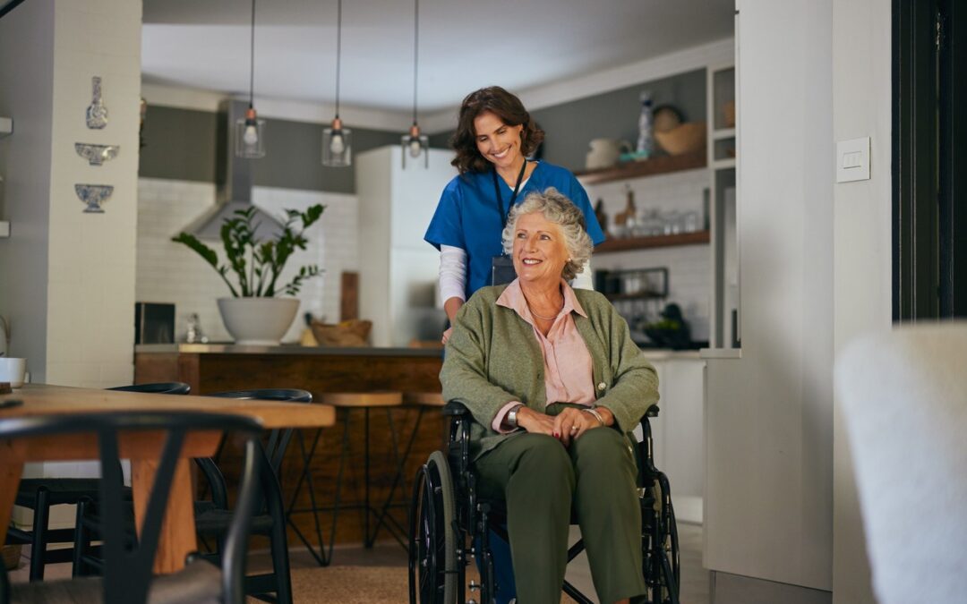 A home health care aide pushes a senior woman in a wheelchair in her home.
