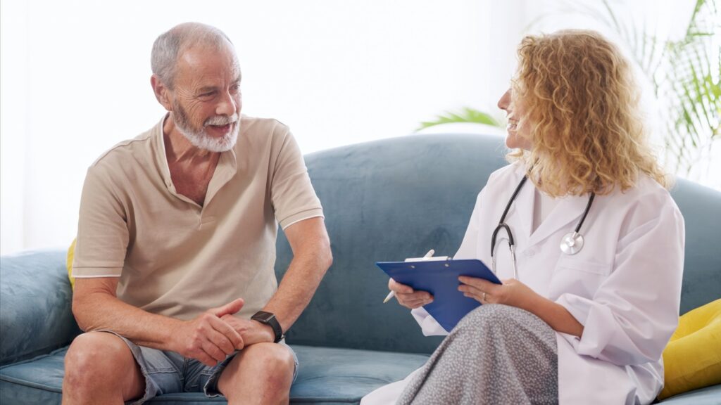 Home health care nurse explaining medication and care instructions to patient during visit